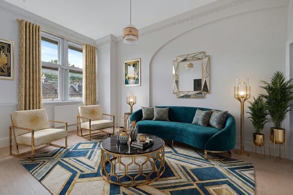 The same room virtually staged in an Art Deco style with teal velvet sofa, geometric rug and gold accents