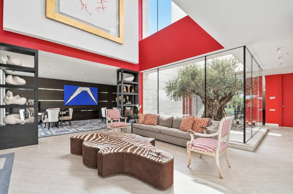 The same red living room virtually staged with a sofa, lounge chairs and a statement coffee table