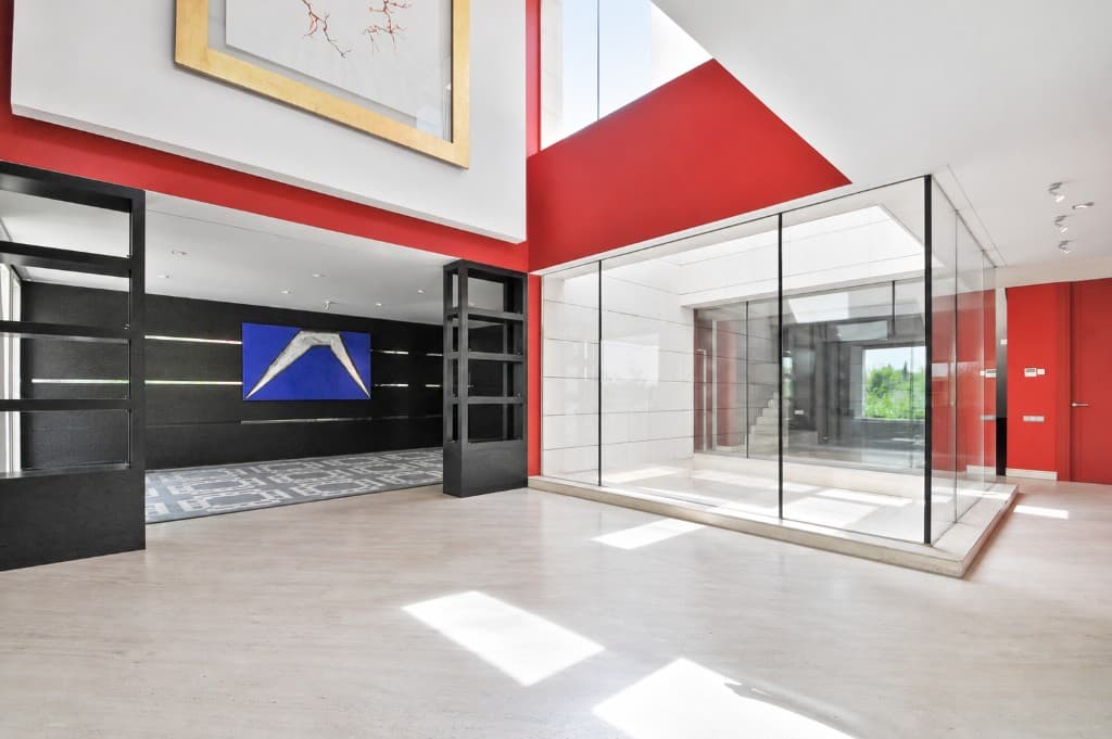 Empty double-height living room with red walls before virtual staging